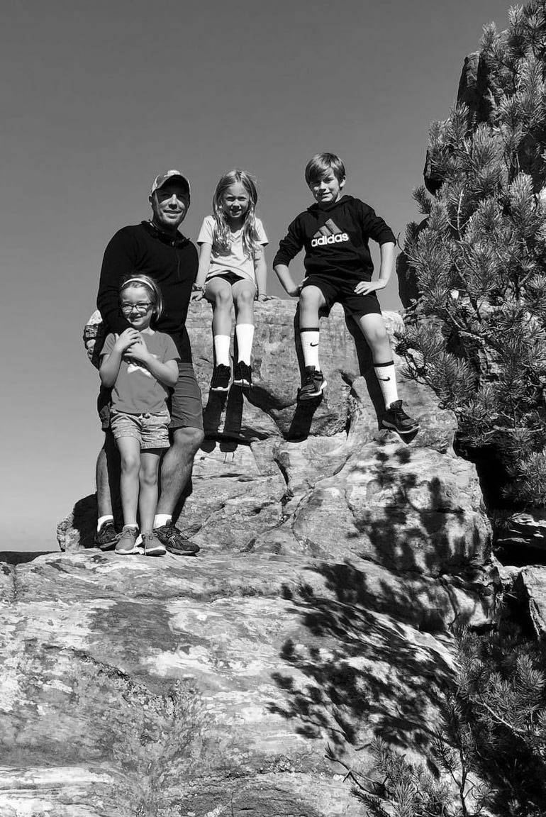 Luke with his kids on a rocky overlook