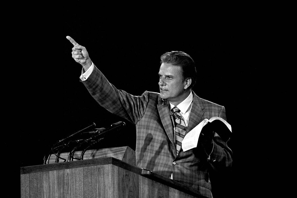 Billy Graham preaching with an open Bible
